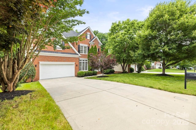 11139 Tradition View Dr, Charlotte, NC 28269 - view of front of home with concrete driveway, brick siding, an attached garage, and a front yard