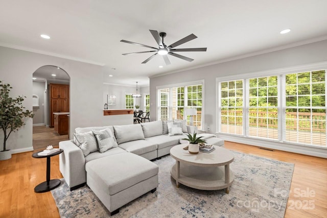 11139 Tradition View Dr, Charlotte, NC 28269 - living room featuring a ceiling fan, arched walkways, wood finished floors, crown molding, and recessed lighting