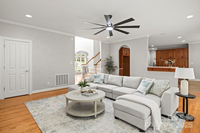 11139 Tradition View Dr, Charlotte, NC 28269 - living room featuring arched walkways, ceiling fan, light wood-style floors, recessed lighting, and ornamental molding