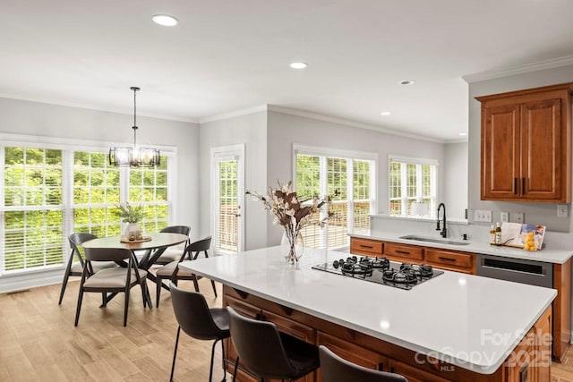 11139 Tradition View Dr, Charlotte, NC 28269 - kitchen with a sink, black gas cooktop, light countertops, light wood-type flooring, and brown cabinets