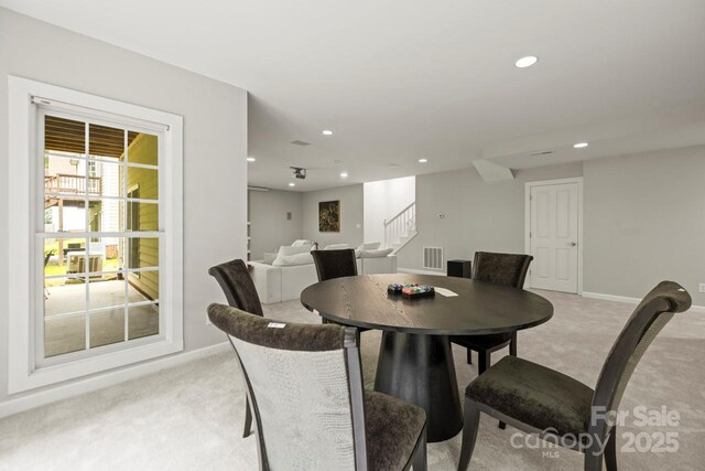 11139 Tradition View Dr, Charlotte, NC 28269 - dining space with light colored carpet, stairway, recessed lighting, and baseboards
