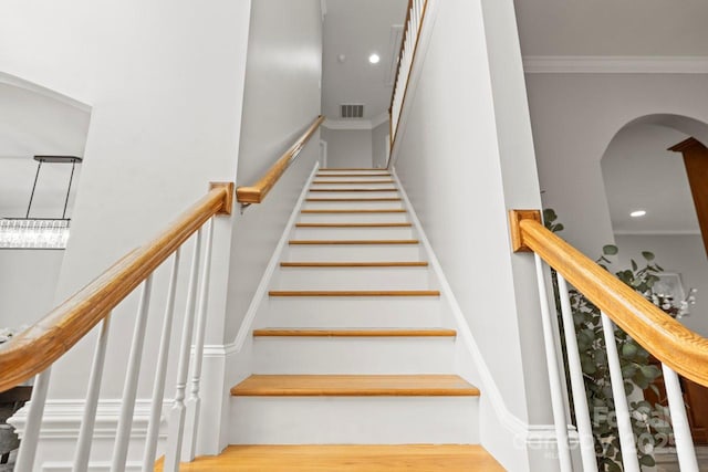 11139 Tradition View Dr, Charlotte, NC 28269 - staircase featuring arched walkways, ornamental molding, and recessed lighting