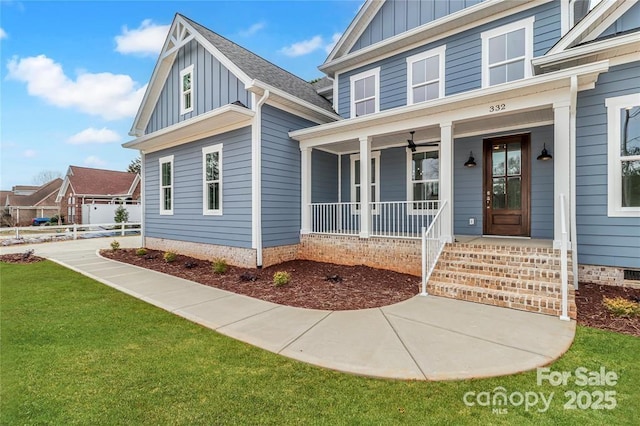 332 Canvasback Rd, Mooresville, NC 28117 - property entrance featuring board and batten siding, a porch, and a lawn
