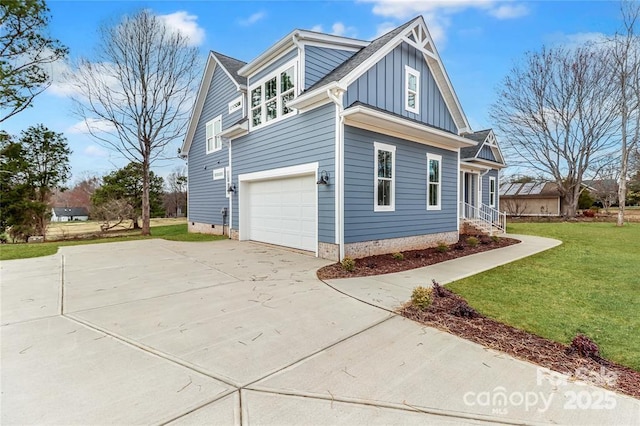 332 Canvasback Rd, Mooresville, NC 28117 - view of side of property with board and batten siding, an attached garage, driveway, and a lawn