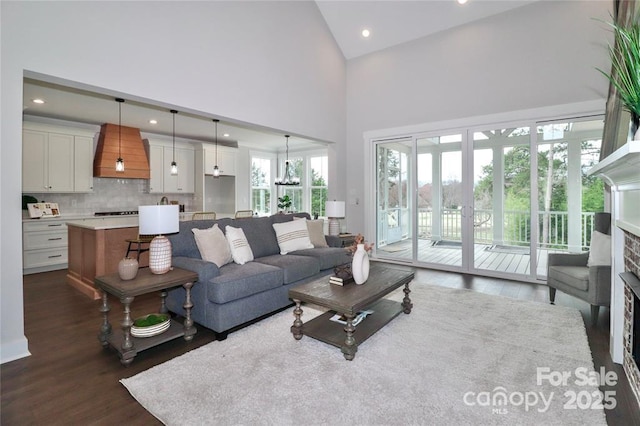 332 Canvasback Rd, Mooresville, NC 28117 - living area with dark wood-type flooring, a towering ceiling, recessed lighting, and a fireplace