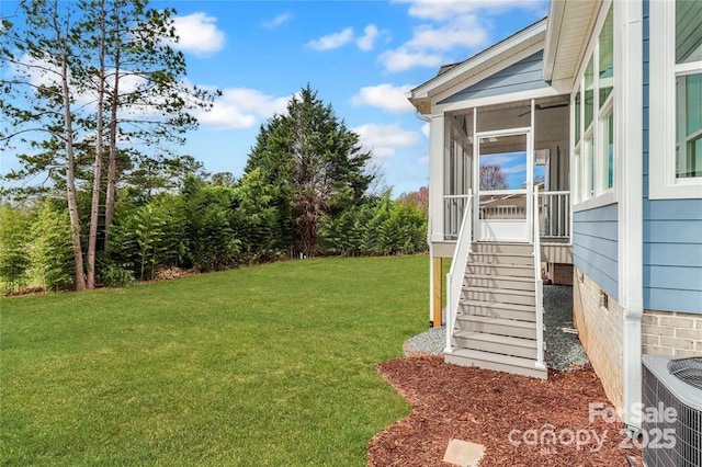 332 Canvasback Rd, Mooresville, NC 28117 - view of grassy yard featuring a sunroom and central AC