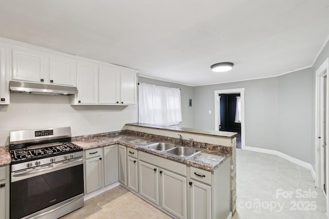 407 Cherry St, Belmont, NC 28012 - kitchen featuring stainless steel range with gas cooktop, under cabinet range hood, a peninsula, a sink, and white cabinetry