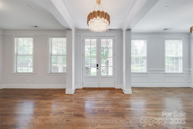 2785 Disney Pl, Indian Land, SC 29707 - entryway featuring crown molding, a chandelier, wood finished floors, french doors, and a decorative wall