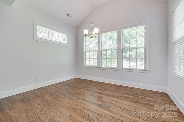 2785 Disney Pl, Indian Land, SC 29707 - spare room featuring lofted ceiling, plenty of natural light, a chandelier, wood finished floors, and baseboards