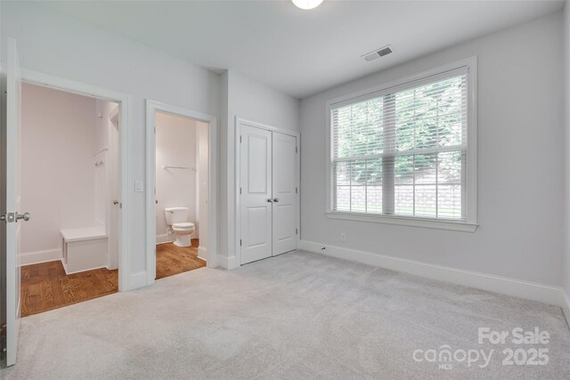 2785 Disney Pl, Indian Land, SC 29707 - unfurnished bedroom featuring carpet, baseboards, ensuite bathroom, and a closet