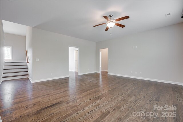 2785 Disney Pl, Indian Land, SC 29707 - empty room with a ceiling fan, stairway, dark wood-style flooring, and baseboards