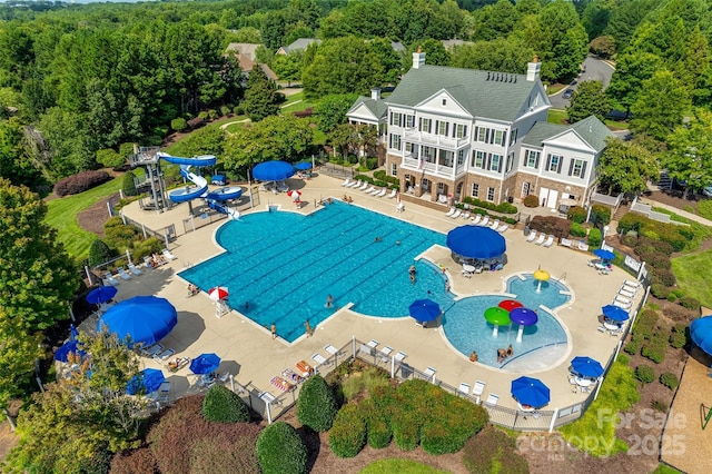 2785 Disney Pl, Indian Land, SC 29707 - view of swimming pool with a water slide, a wooded view, a water play area, and a patio