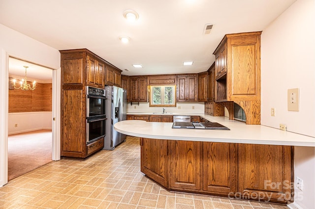 1304 5th Street Cir NW, Hickory, NC 28601 - kitchen featuring stainless steel appliances, light countertops, a peninsula, a sink, and brick patterned floors