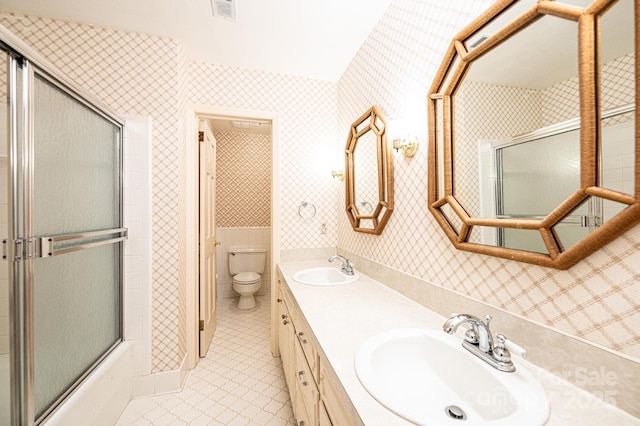 1304 5th Street Cir NW, Hickory, NC 28601 - bathroom featuring toilet, tile patterned flooring, double vanity, wallpapered walls, and enclosed tub / shower combo