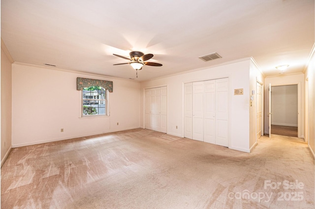 1304 5th Street Cir NW, Hickory, NC 28601 - unfurnished bedroom with crown molding, multiple closets, light carpet, baseboards, and a ceiling fan