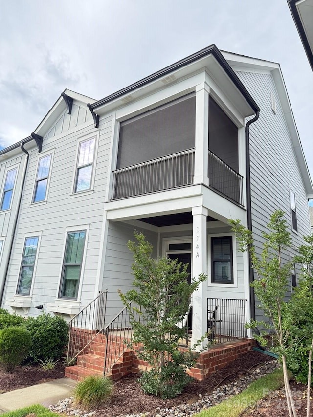 114 Mint Ave Unit A, Mooresville, NC 28117 - view of front of house with a balcony, board and batten siding, and a porch