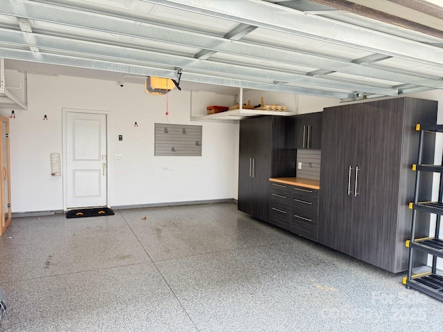 114 Mint Ave Unit A, Mooresville, NC 28117 - garage with a garage door opener and baseboards