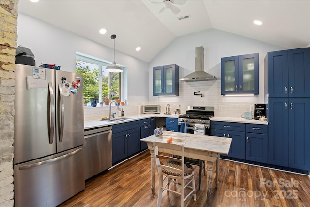 111 Altamahaw Ave, Black Mountain, NC 28711 - kitchen featuring stainless steel appliances, wall chimney range hood, blue cabinetry, vaulted ceiling, and ceiling fan