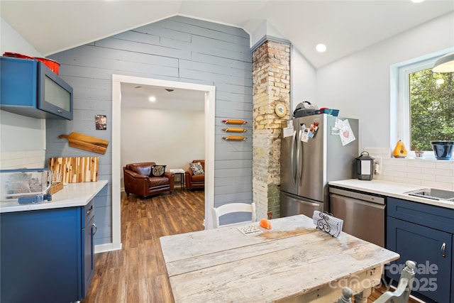 111 Altamahaw Ave, Black Mountain, NC 28711 - kitchen featuring blue cabinets, vaulted ceiling, appliances with stainless steel finishes, dark wood-style floors, and wood walls