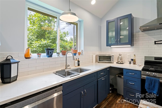111 Altamahaw Ave, Black Mountain, NC 28711 - kitchen with appliances with stainless steel finishes, wall chimney exhaust hood, vaulted ceiling, blue cabinets, and glass insert cabinets