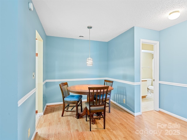 110 Heywood Rd Unit 17C, Arden, NC 28704 - dining room with wood finished floors, baseboards, and a textured ceiling