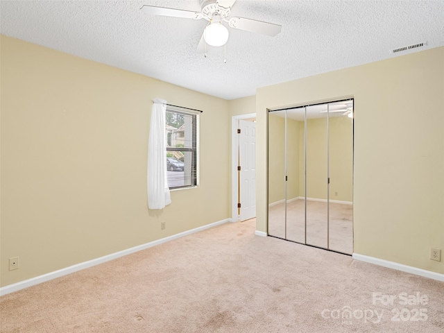 110 Heywood Rd Unit 17C, Arden, NC 28704 - unfurnished bedroom with carpet, a textured ceiling, a closet, baseboards, and ceiling fan