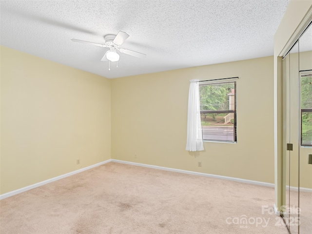 110 Heywood Rd Unit 17C, Arden, NC 28704 - unfurnished room featuring light carpet, a ceiling fan, baseboards, and a textured ceiling