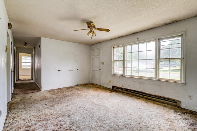 798 Wilson St, China Grove, NC 28023 - carpeted spare room with a baseboard heating unit, a ceiling fan, a textured ceiling, and baseboards