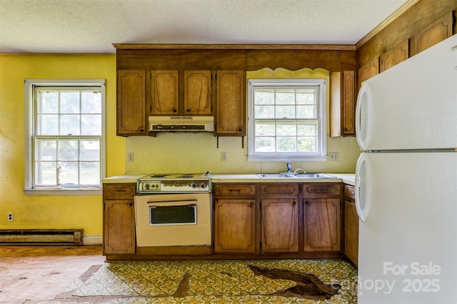 798 Wilson St, China Grove, NC 28023 - kitchen with freestanding refrigerator, range with electric stovetop, under cabinet range hood, a sink, and baseboard heating