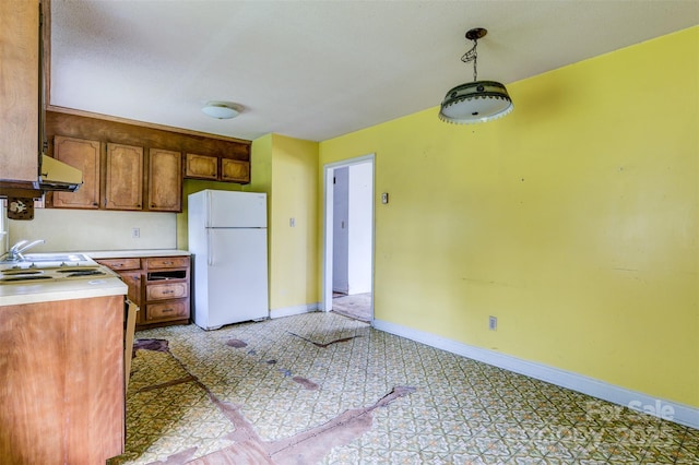 798 Wilson St, China Grove, NC 28023 - kitchen featuring freestanding refrigerator, light countertops, exhaust hood, baseboards, and pendant lighting