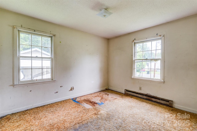 798 Wilson St, China Grove, NC 28023 - unfurnished room featuring a baseboard radiator, plenty of natural light, light carpet, baseboards, and a textured ceiling