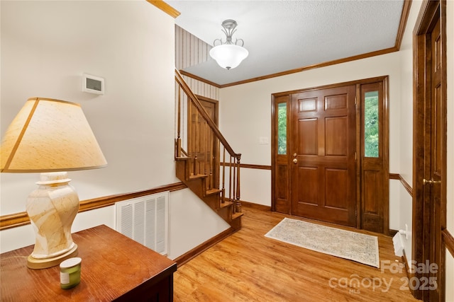 4848 Spicewood Dr, Charlotte, NC 28227 - entryway featuring light wood finished floors, stairs, ornamental molding, and baseboards