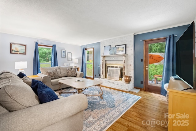 4848 Spicewood Dr, Charlotte, NC 28227 - living area with wood finished floors, healthy amount of natural light, a brick fireplace, and crown molding