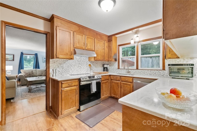 4848 Spicewood Dr, Charlotte, NC 28227 - kitchen with stainless steel appliances, under cabinet range hood, light wood-style floors, light countertops, and crown molding