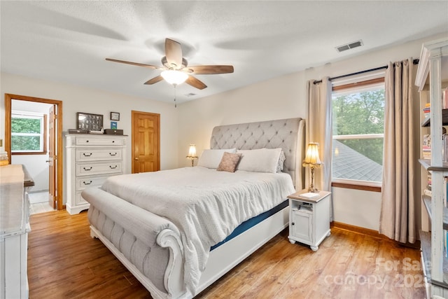 4848 Spicewood Dr, Charlotte, NC 28227 - bedroom featuring light wood-style floors, multiple windows, baseboards, and a ceiling fan