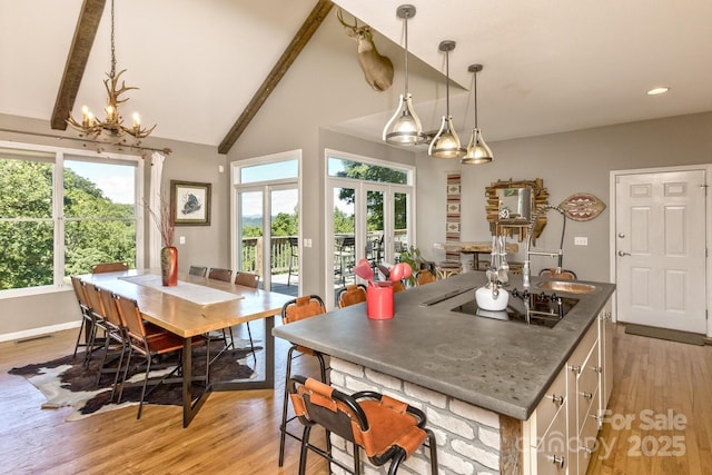 28 Mountain Vista Dr Unit 1 & 2, Asheville, NC 28804 - kitchen with a chandelier, black electric stovetop, light wood-style flooring, decorative light fixtures, and recessed lighting