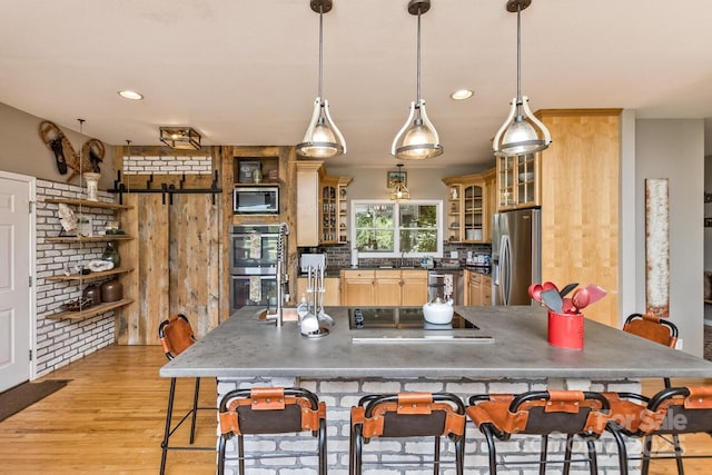 28 Mountain Vista Dr Unit 1 & 2, Asheville, NC 28804 - kitchen featuring stainless steel appliances, light wood-style floors, a sink, dark countertops, and a breakfast bar area