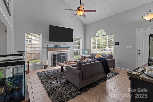 8906 Pickering Grove Ln, Charlotte, NC 28216 - living room featuring high vaulted ceiling, tile patterned flooring, a ceiling fan, a fireplace, and healthy amount of natural light