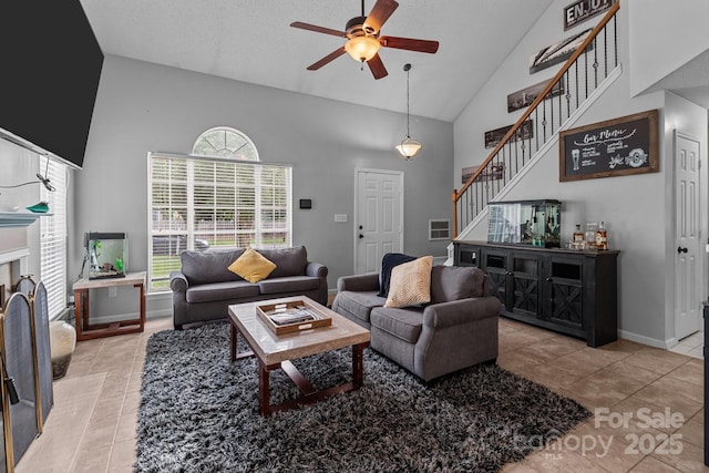 8906 Pickering Grove Ln, Charlotte, NC 28216 - living room with high vaulted ceiling, ceiling fan, stairs, and light tile patterned floors