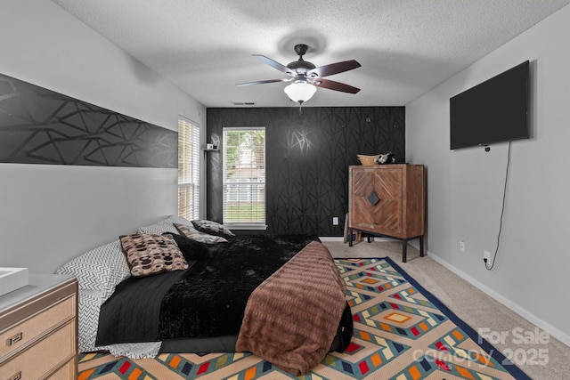 8906 Pickering Grove Ln, Charlotte, NC 28216 - bedroom with a textured ceiling, an accent wall, carpet floors, and ceiling fan