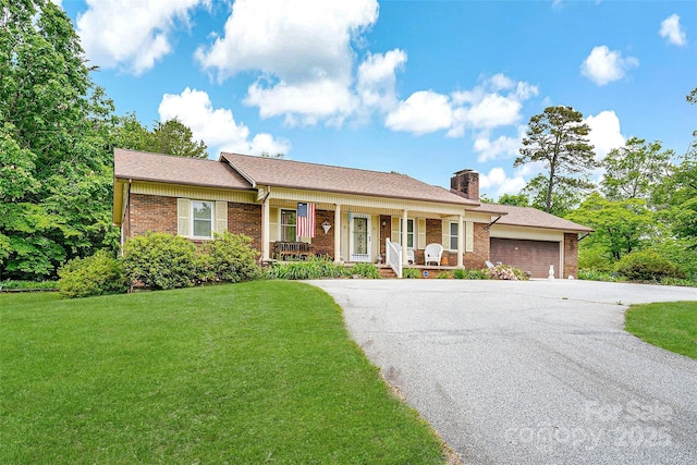 7050 W US-70 Hwy, Old Fort, NC 28762 - ranch-style home with covered porch, an attached garage, a chimney, brick siding, and asphalt driveway