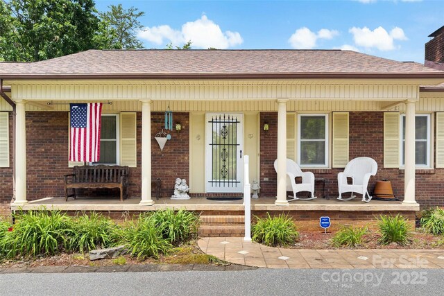 7050 W US-70 Hwy, Old Fort, NC 28762 - bungalow-style home with a porch, brick siding, and a shingled roof