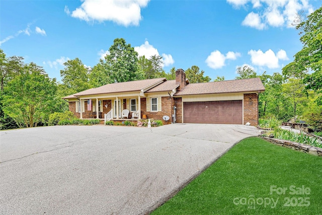 7050 W US-70 Hwy, Old Fort, NC 28762 - ranch-style home featuring covered porch, a garage, concrete driveway, brick siding, and a chimney