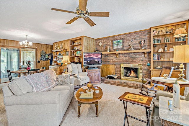 7050 W US-70 Hwy, Old Fort, NC 28762 - carpeted living area with wooden walls, a ceiling fan, a chandelier, and a brick fireplace
