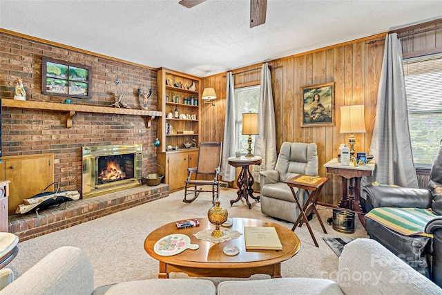 7050 W US-70 Hwy, Old Fort, NC 28762 - living room with carpet floors, ceiling fan, a fireplace, wooden walls, and a textured ceiling