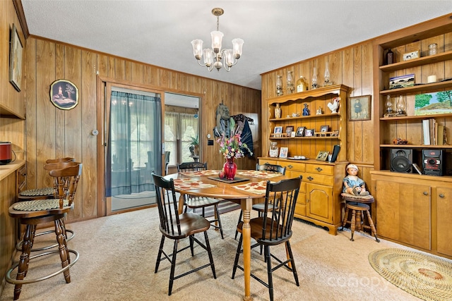 7050 W US-70 Hwy, Old Fort, NC 28762 - dining space featuring wooden walls, light carpet, a chandelier, and crown molding