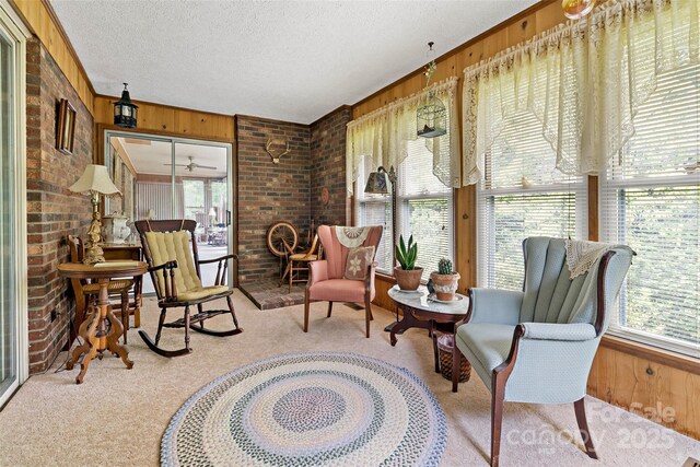 7050 W US-70 Hwy, Old Fort, NC 28762 - sunroom featuring carpet flooring, wood walls, brick wall, and a textured ceiling
