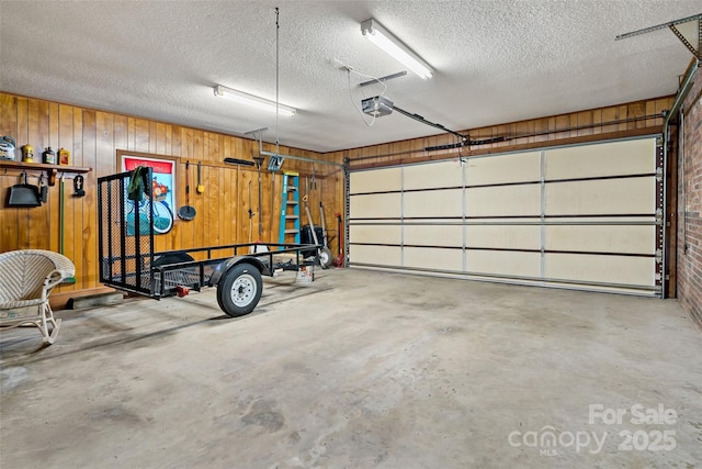 7050 W US-70 Hwy, Old Fort, NC 28762 - garage featuring a garage door opener and wooden walls