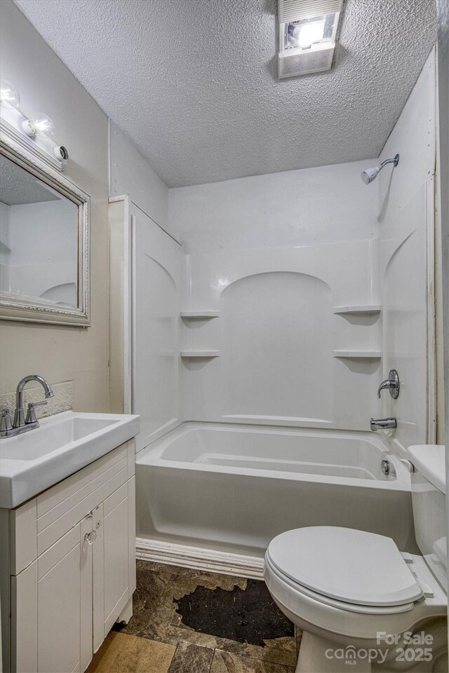 1036 20th St NE, Hickory, NC 28601 - full bathroom featuring toilet, vanity, a textured ceiling, tub / shower combination, and stone finish flooring