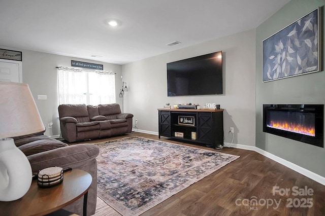 2013 Eastway Dr, Dallas, NC 28034 - living area with wood finished floors, a glass covered fireplace, and baseboards